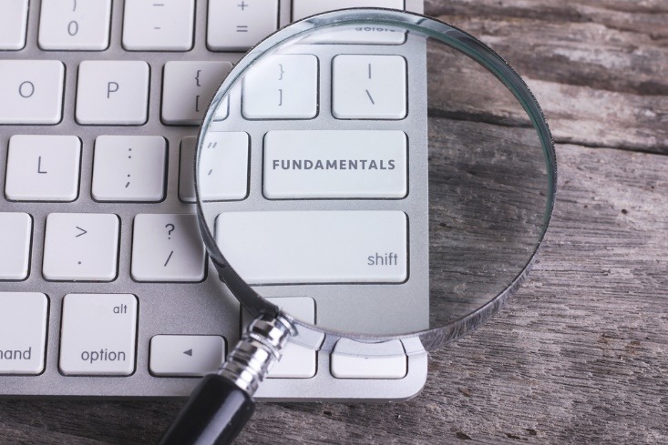 fundamentals seen under a magnifying glass on a keyboard - myforexnews