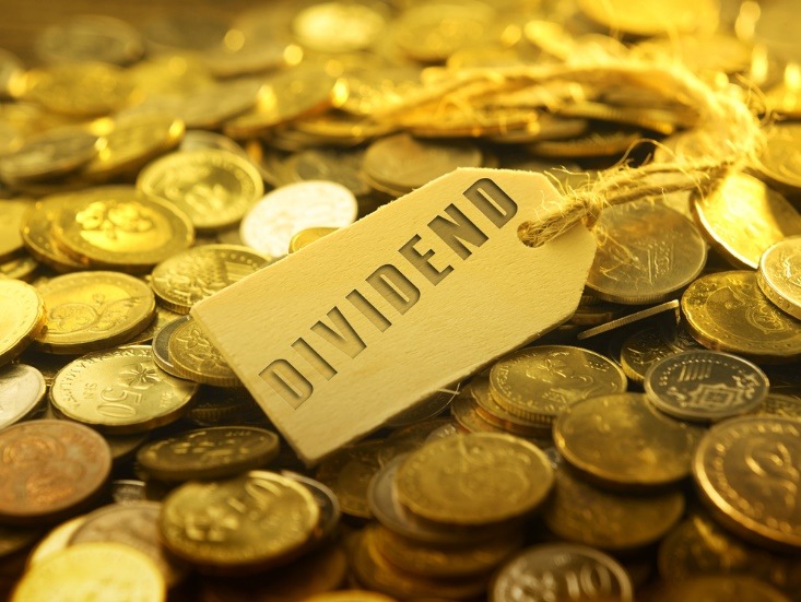 dividends written on a price tag above coins - myforexnews