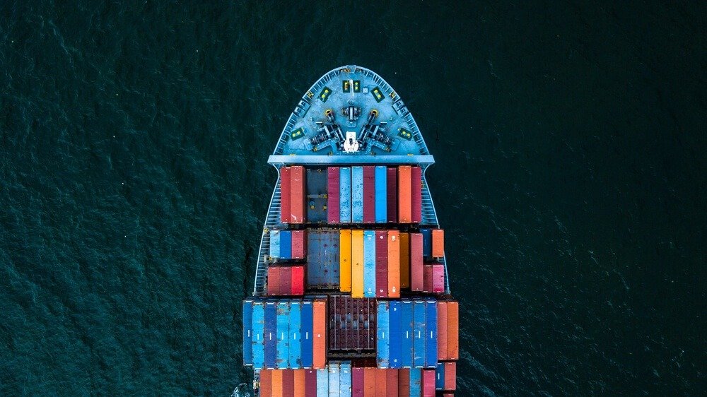 Carry Trade: Container ship carrying container for import and export.