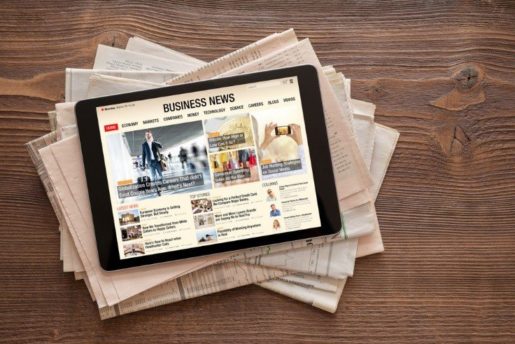 business news on tablet on top of newspapers – myforexnews 
