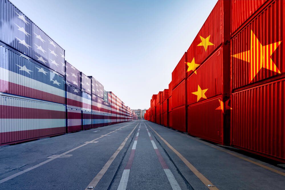 U.S.-China Trade War: United States of America and China trade war tariffs as two opposing container cargo.