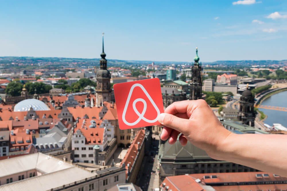 airbnb logo held by a traveler