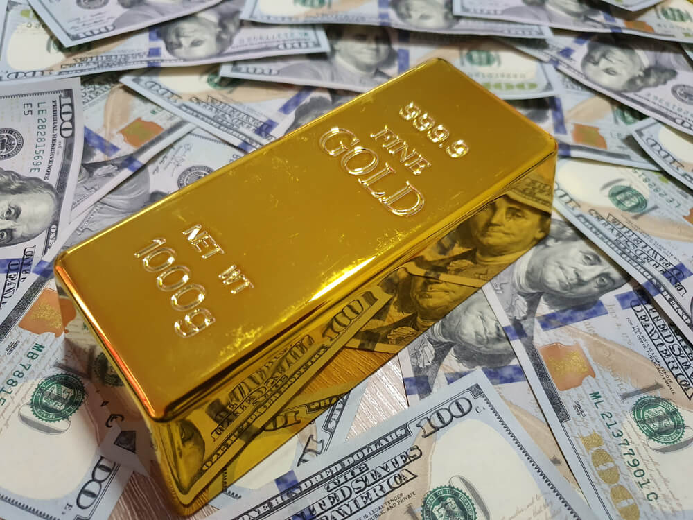 gold bar in a stack of us dollar